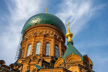 The Green Dome and Golden Cross of Saint Sophia Cathedral Against a Blue Sky © Dong