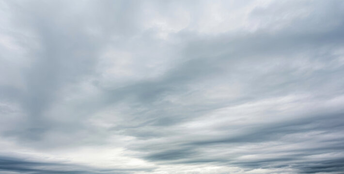 Overcast sky filled with layers of dark and light gray storm clouds, forming a dramatic atmosphere of approaching rain and tension in the air, symbolizing strength and change in nature.