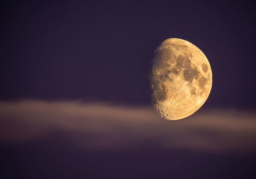 Dramatic waxing gibbous moon with visible craters in a dark night sky - Powered by Adobe