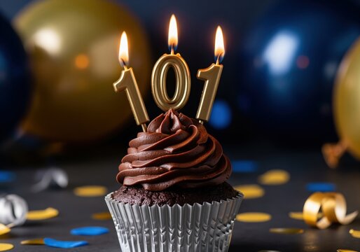 Decadent chocolate cupcake with 101 gold candles, perfect for a milestone celebration
