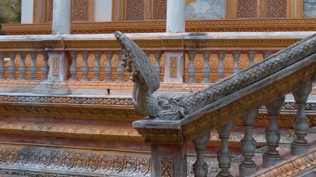 Seven headed serpent or naga statue guarding the entrance to Wat Svay Romeat Pagoda in Siem Reap, Cambodia. Shot in motion
