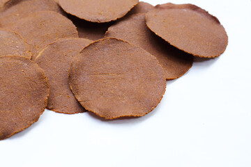 Fermented soybean discs, known as “Thua Nao,” a traditional Thai seasoning used to enhance...