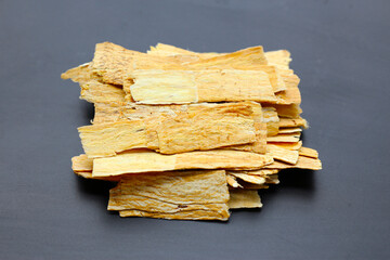 Dried Astragalus root slices used in traditional Chinese medicine.