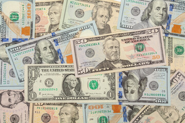Horizontal collage of dollar bills of various denominations