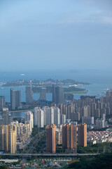 Obraz premium Urban Skyline and Coastal Landscape Featuring Modern High-Rise Buildings and a Vast Seaside View