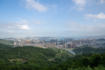Harmony Between City and Nature: A Panoramic View of a Modern Urban Landscape from the Hills
