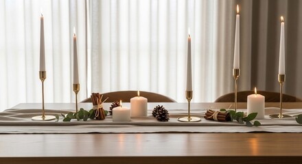 Lit candles in gold holders atop runner accented by cinnamon sticks pine cones  eucalyptus on a wooden table against a curtain background