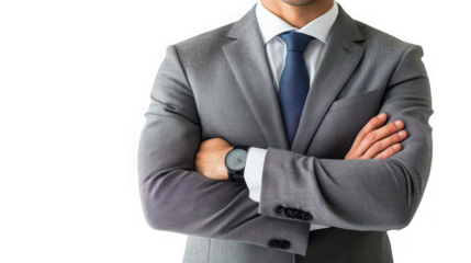 Man in a gray suit with arms crossed wearing a watch against a black background in a studio shot