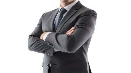 A torso view of a man in a gray suit with his arms crossed against a black background in a studio shot