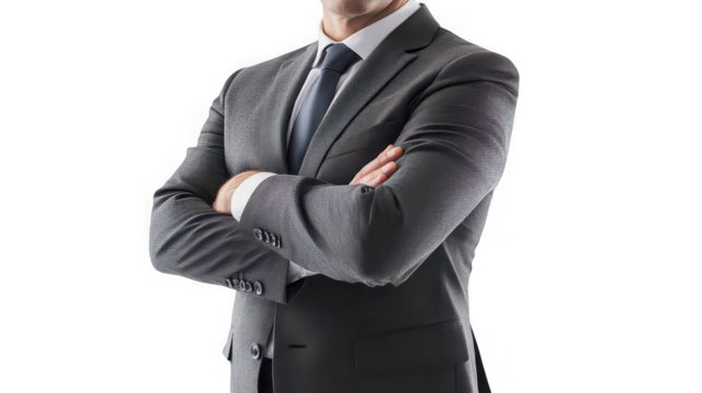 A torso view of a man in a gray suit with his arms crossed against a black background in a studio shot