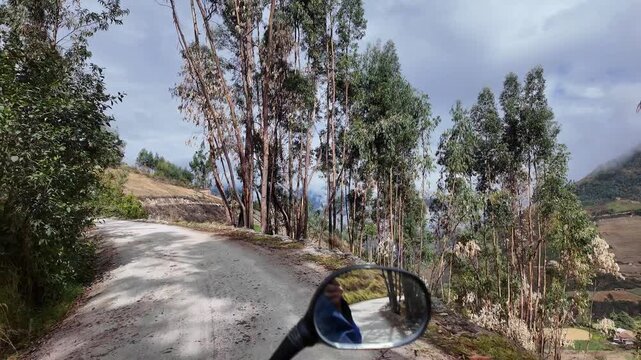 Huaraz, Peru: Point of view footage of riding motorcycle on the small road to Laguna Paron, mountain lake in Cordillera Blanca situated in border of Huascaran National Park, Peru. 