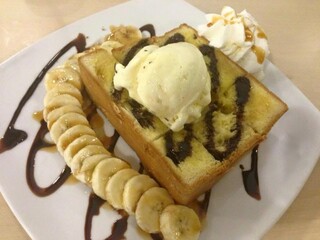 square plate of Honey Toast. Bread buttered toast. Topped with ice-cream, banana decorations