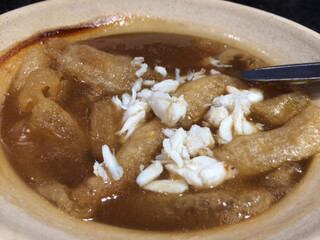 Fish bladder, fish maw in brown soup topped with crab meat