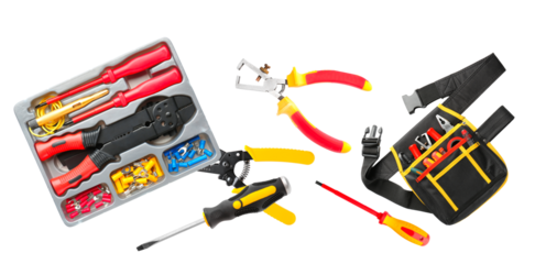 various professional electrician tools scattered across the frame, including insulated pliers, screwdrivers, wire strippers, and a practical tool belt, isolated on black.