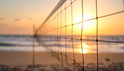 Beach volleyball net silhouetted by a beautiful golden sunset over the tranquil ocean, embodying peaceful summer evenings and coastal sports