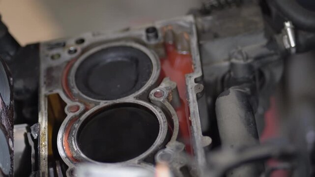 Open block of four cylinder petrol engine in repair shop