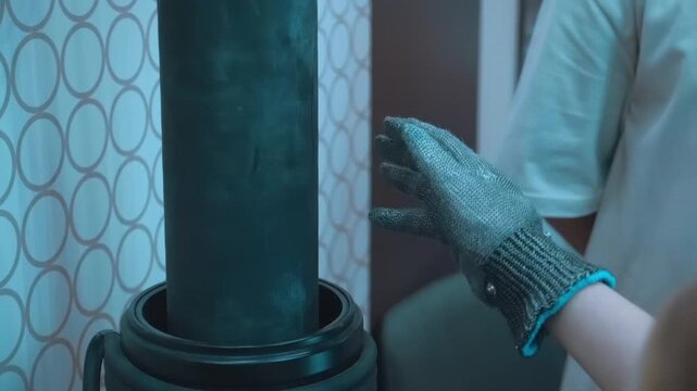 A lightning bolt emerges from a metal glove on a guy's hand and hits a Tesla coil. Closeup. Slow mo, slow motion, high speed camera
