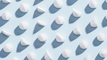 shallow. White tablets arranged in a geometric pattern on a light blue surface. STEM education sheets, lab safety posters, designed for biotech research communications, used by art directors.