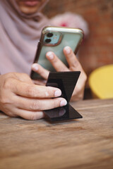 Person using smartphone to scan QR code for cafe menu 