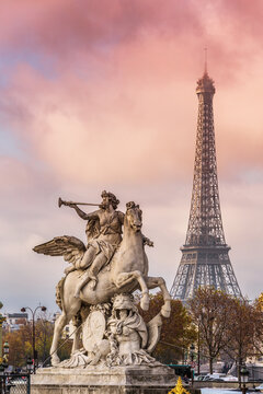 Eiffel tower and statue de la Renomee at sunset, Paris, France