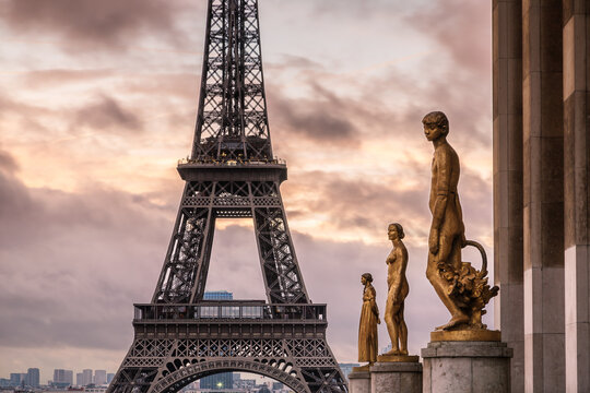Sunrise over Eiffel tower and statues, Paris, France