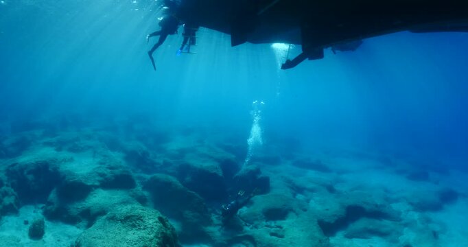 scubadivers coming back to the boat from a dive 