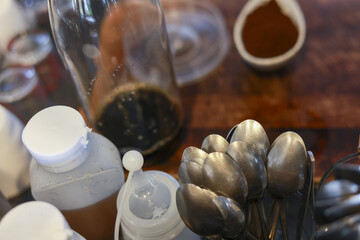 Authentic coffee preparation in cozy cafe kitchen. closeup of spoon, bottle, and fresh ingredient...