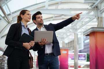 Business people walking and talking together in modern city.