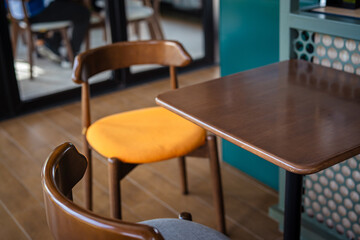 Empty wooden chair in modern coffee shop