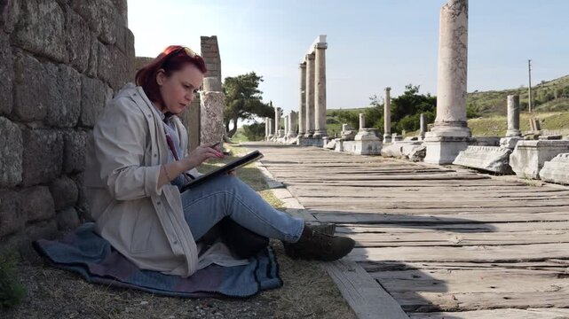 Archeology Student Working with a Tablet in the Acropolis of the Historical City of Pergamon