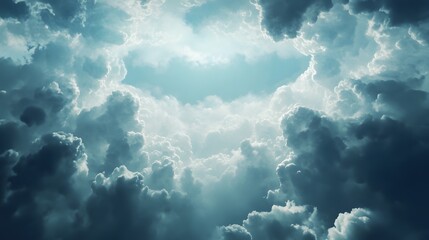 Fototapeta premium A dramatic sky with dark storm clouds surrounding a bright light.