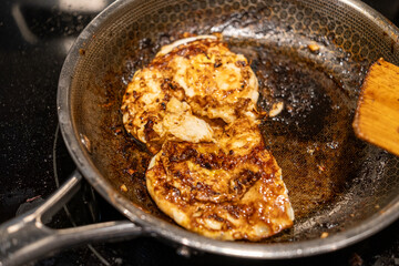 Delicious Chicken Breasts Cooking in a Skillet on a Stovetop