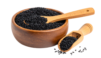Wooden bowl and scoops filled with small black seeds, isolated on black background
