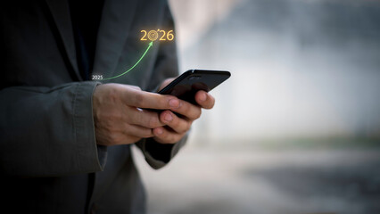 Businessman touching 2026 with arrow target icon, representing new year business goal, strategic...