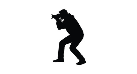 Silhouette of a photographer in action capturing a moment with a professional camera against a white background
