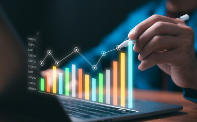 Professional businessman analyzing digital business data on a laptop, illustrating upward growth, success, and strategic financial planning through colorful statistical charts and technology.