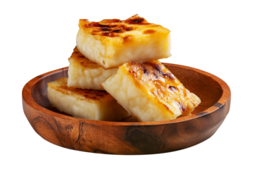 Cassava syrup-drenched semolina coconut cake pieces stacked on wooden plate isolated on white transparent background, concept of Fijian Cuisine and traditional dessert