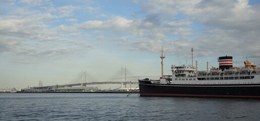 Yokohama Bay Bridge and the historic ship Hikawa Maru moored in Yokohama Port, a Japanese tourist destination