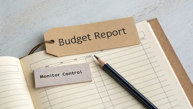Detailed Budget Report on Notepad with Label and Pencil for Financial Monitoring and Control Analysis in Office Environment