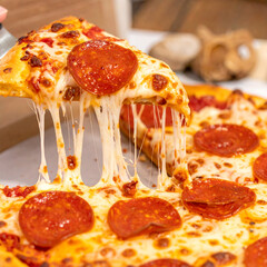 Close up view of delicious pepperoni pizza slice with melted cheese