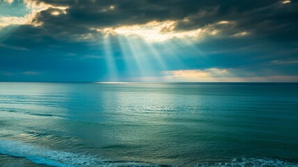 Stunning ocean view with sun rays breaking through dramatic clouds