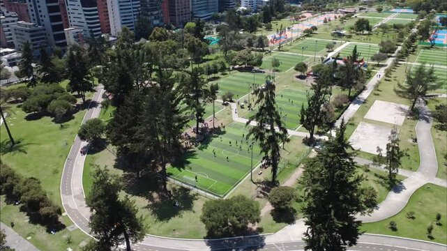 Aerial panoramic drone shot of sports courts at La Carolina Park in Quito.
