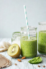 Refreshing green smoothie in a jar with kiwi and spinach