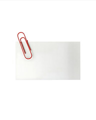 Red paperclip holding a white note card on a white background