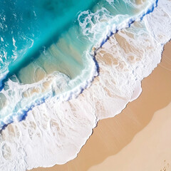 Aerial view of ocean waves crashing onto sandy beach with turquoise water