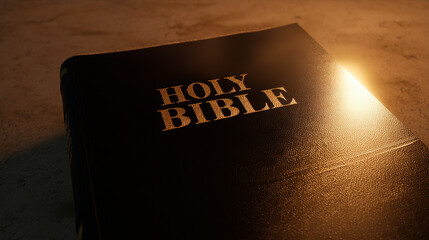 Holy Bible's beacon: A weathered bible, its gold lettering aglow under a spotlight, symbolizes faith, spirituality, and sacred scripture.
