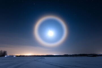 A moonlit sun halo effect appearing in a late-night sky