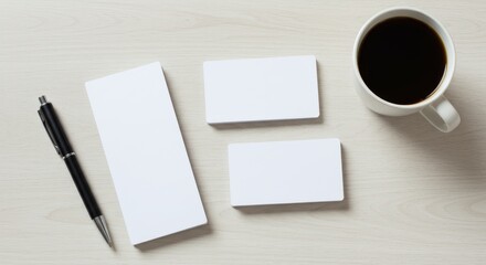 White notepad, business cards, pen, coffee.