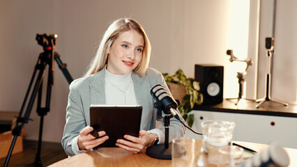 Talk show, microphone and businesswoman in studio with tablet for online subscribers with podcast. Happy, digital technology and female radio host with live streaming, recording or broadcast.