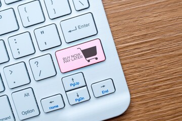 A keyboard key labeled "BUY NOW PAY LATER" with a shopping cart icon. Installment payment options in e-commerce and online shopping concept.